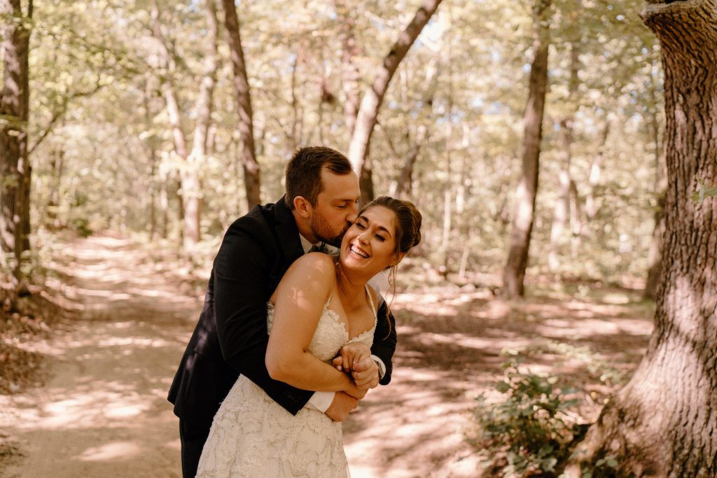 Bride and Groom Hugging and Laughing in the Forest