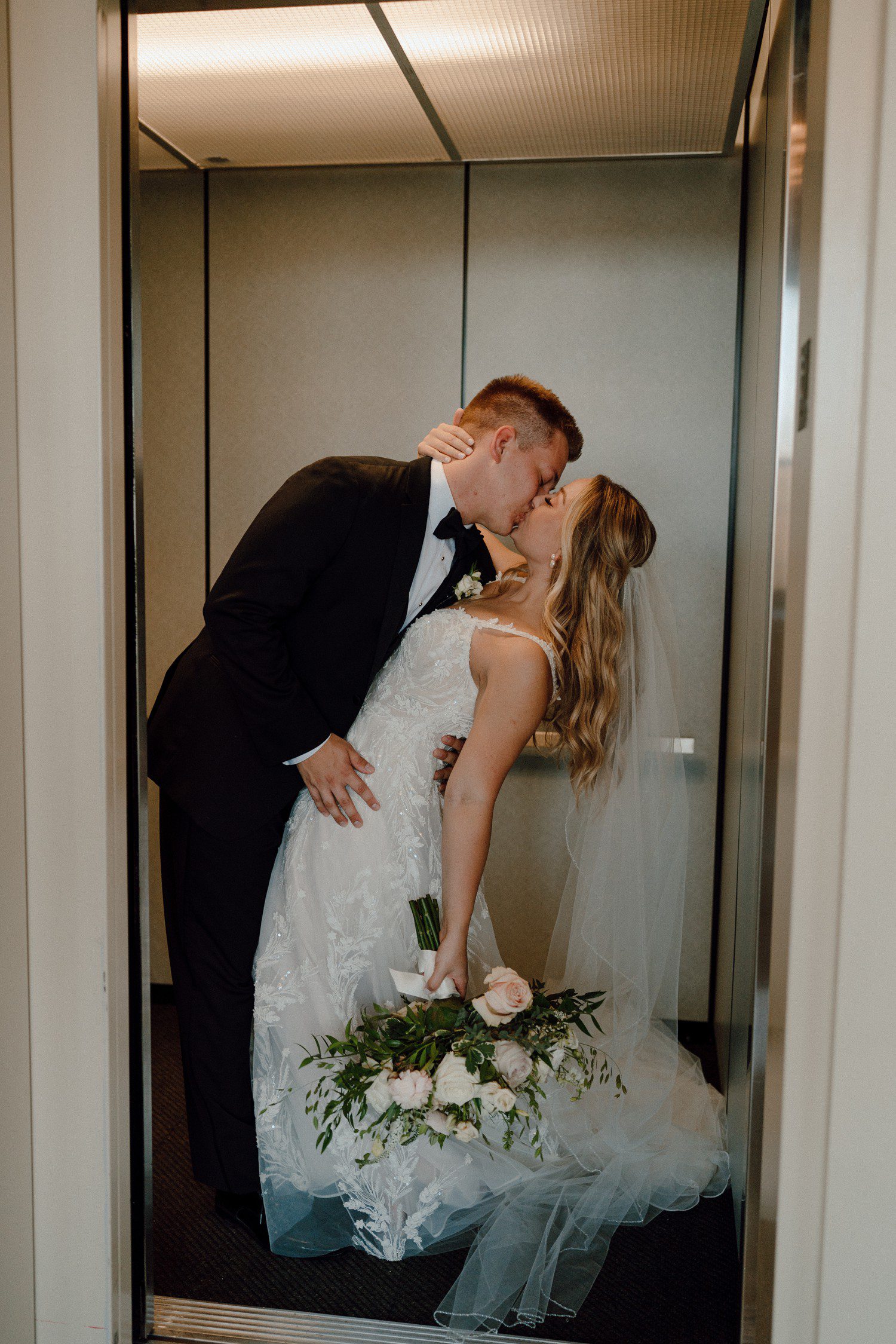 Bride and Groom Elevator Kiss