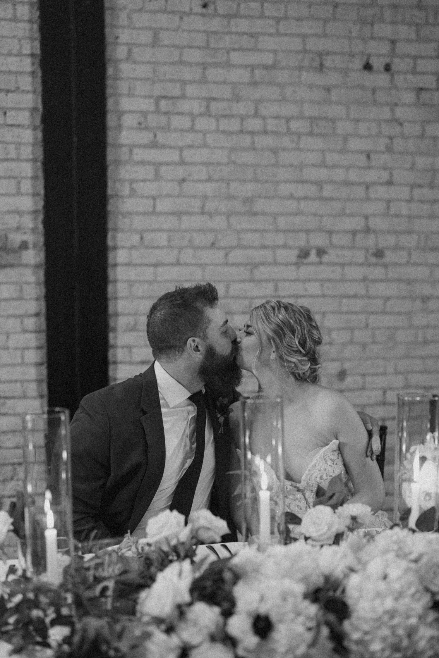 Bride and Groom kiss at head table 