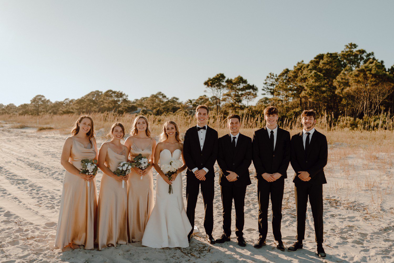 Wedding party photos on beach in champagne bridesmaid dresses