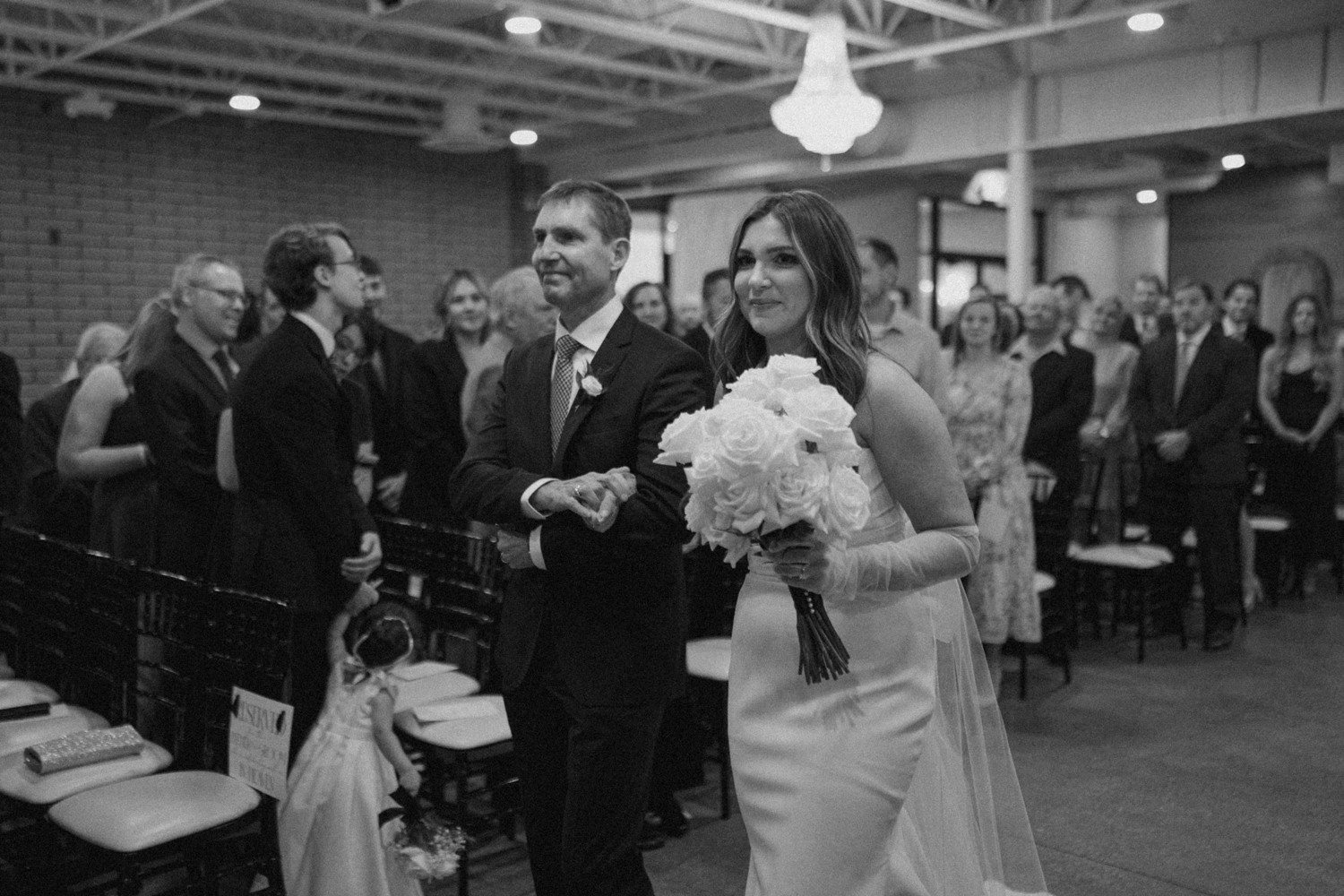 Bride walking down aisle at Port 393 in Holland MI.
