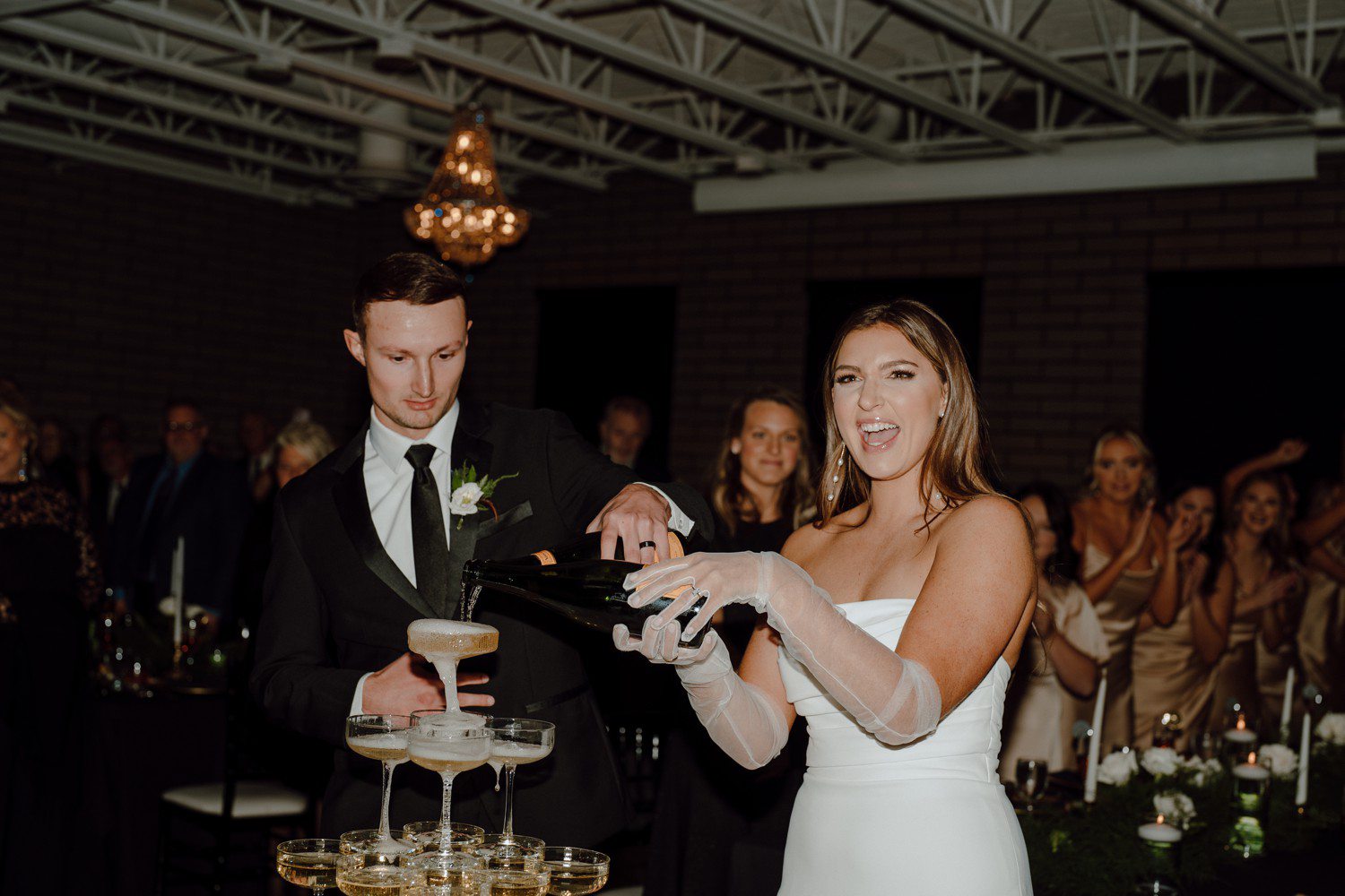 Bride and groom champagne wedding tower pour.