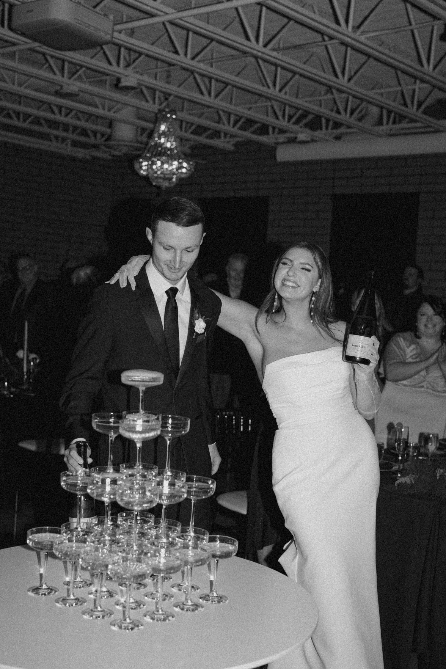 Bride and Groom champagne wedding tower pour