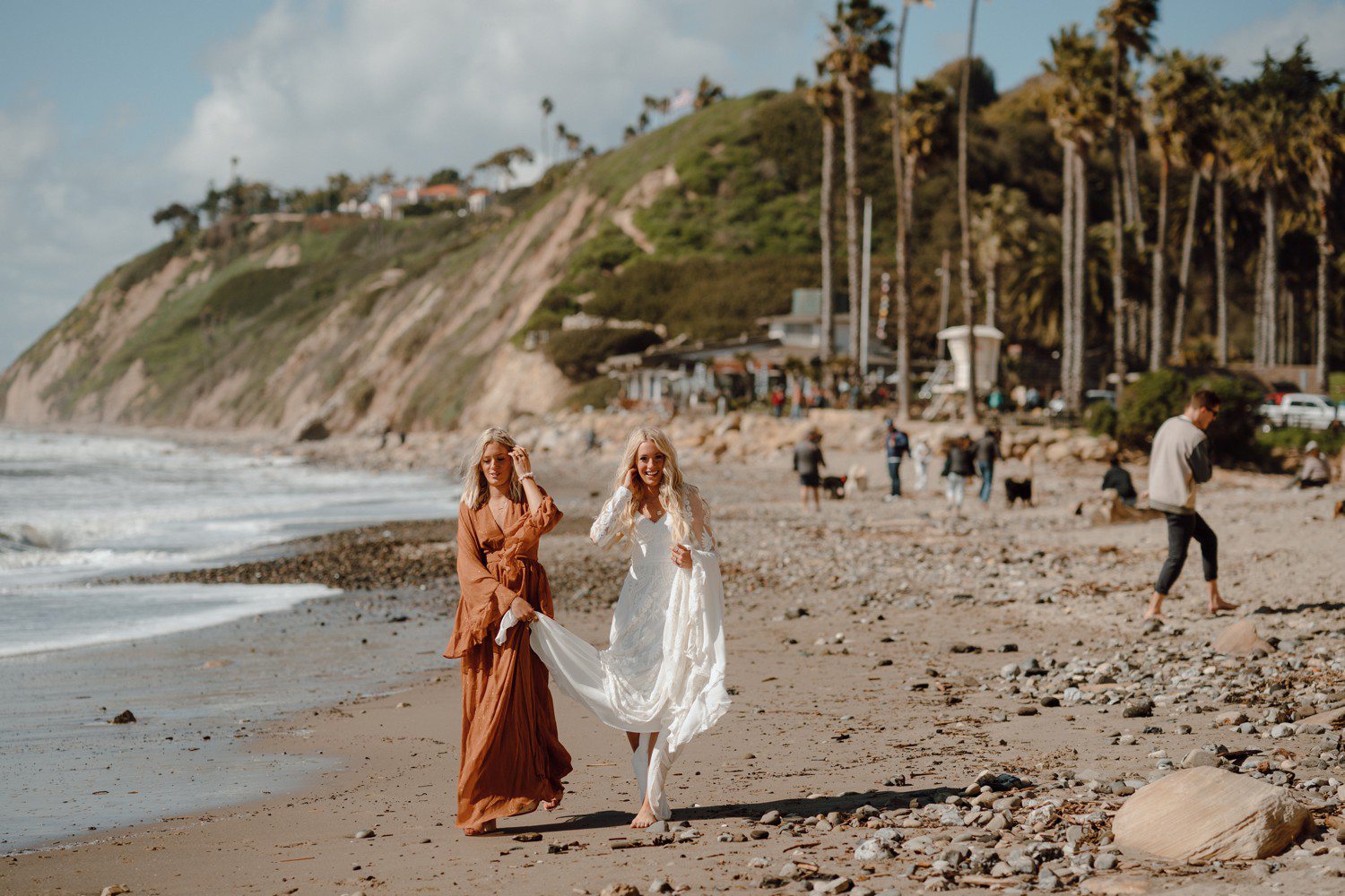 Bride walking on beach in Santa Barbara. 