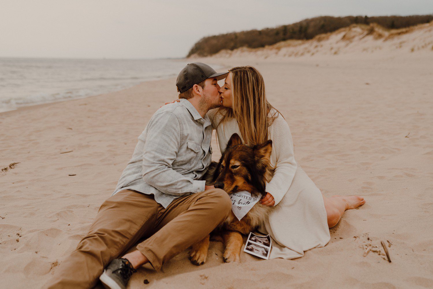 Grand Haven Beach Pregnancy Announcement photos with dog 