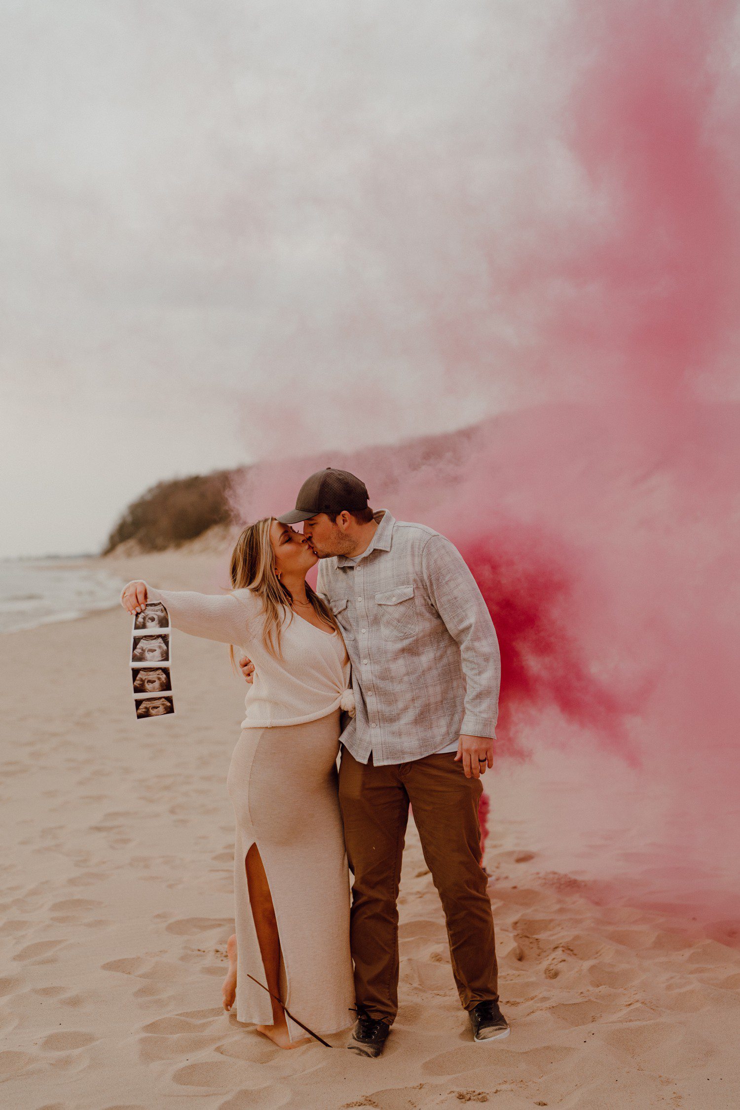 Pink gender reveal photos with smoke bomb