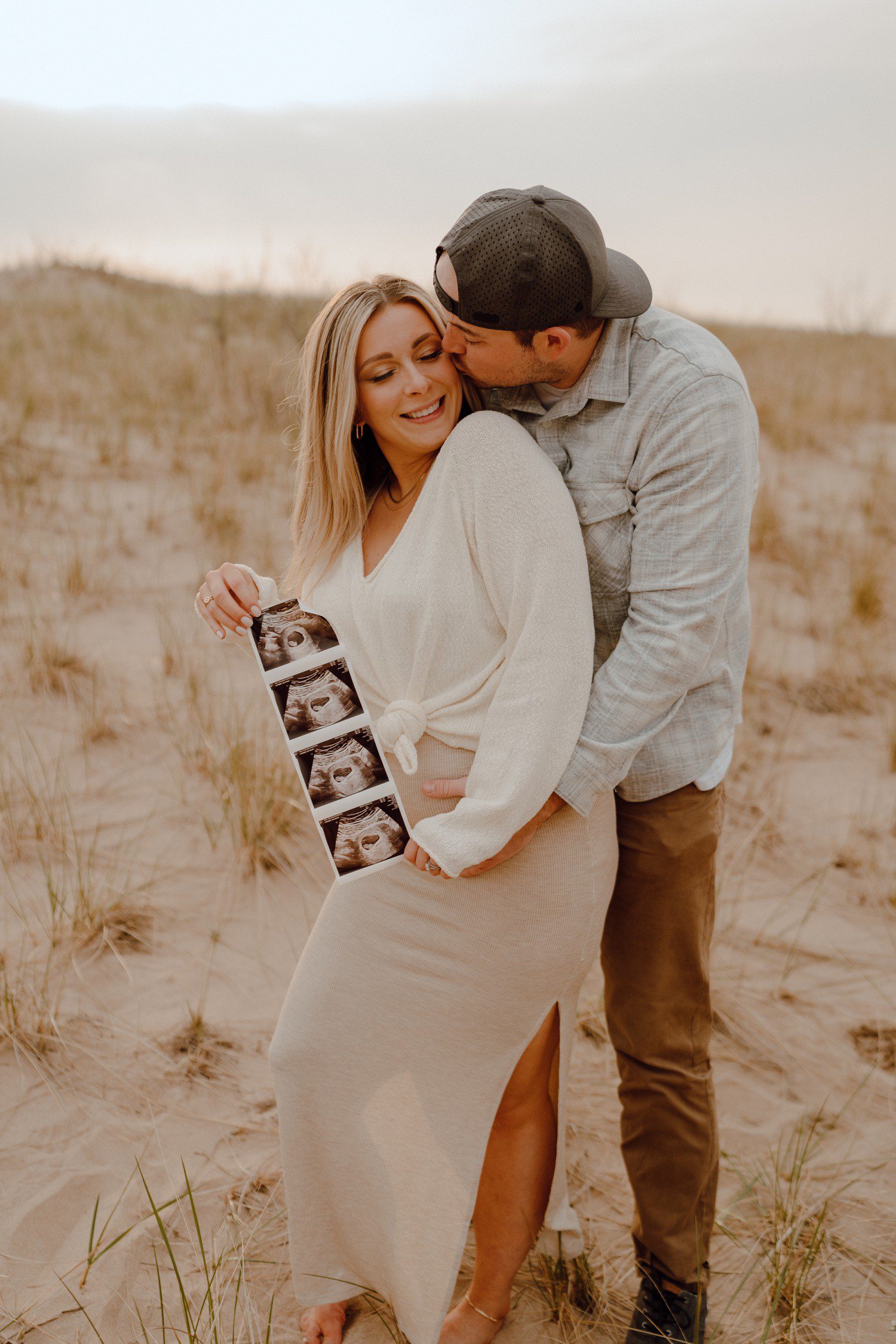 Pregnancy announcement photos at Grand Haven Beach Michigan. 