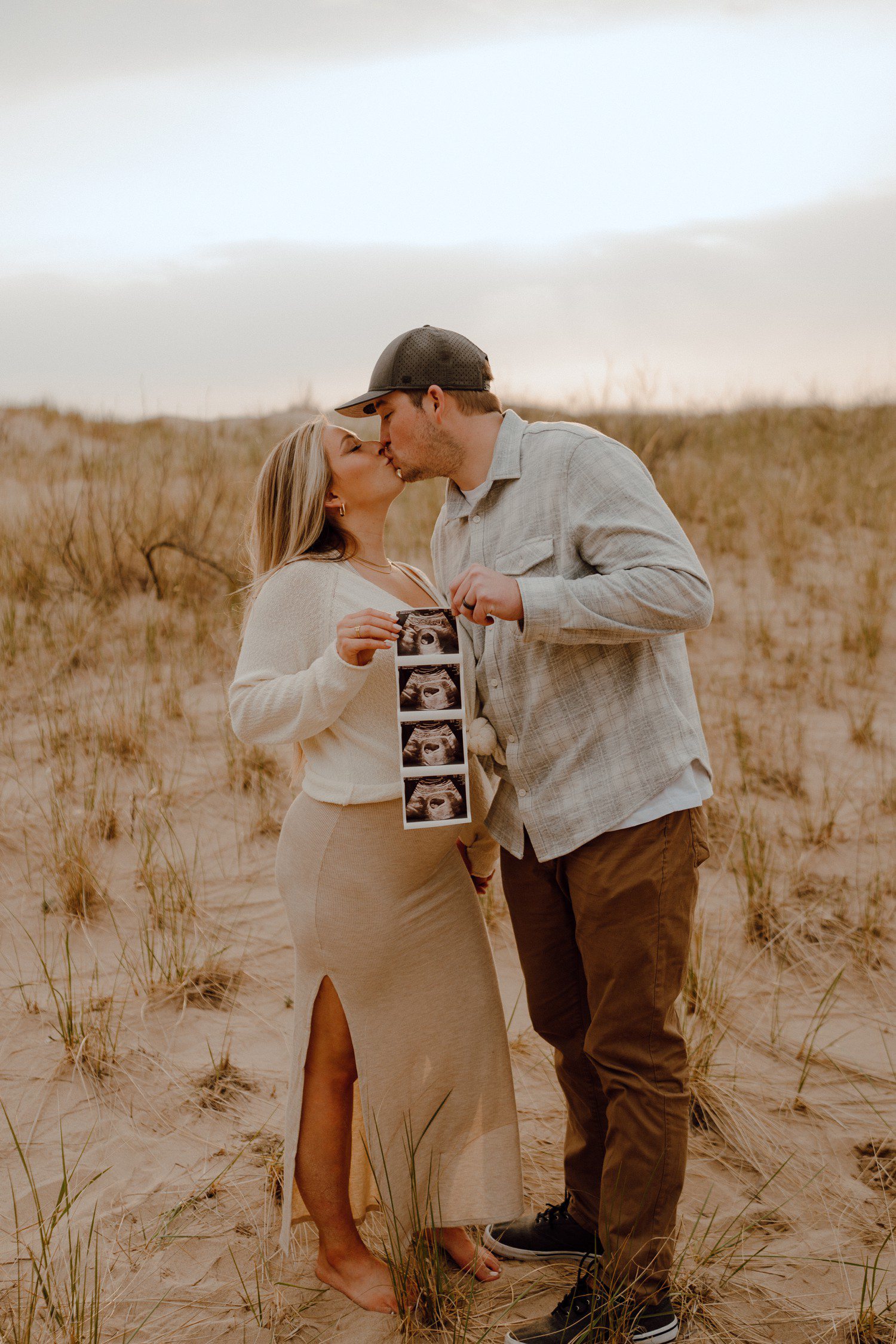 pregnancy announcement photos on the beach with sonogram