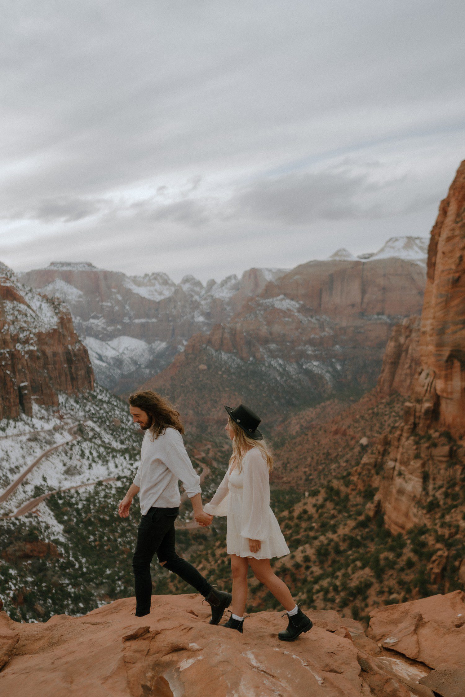 Couple walking at canyon overlook in Zion National Park