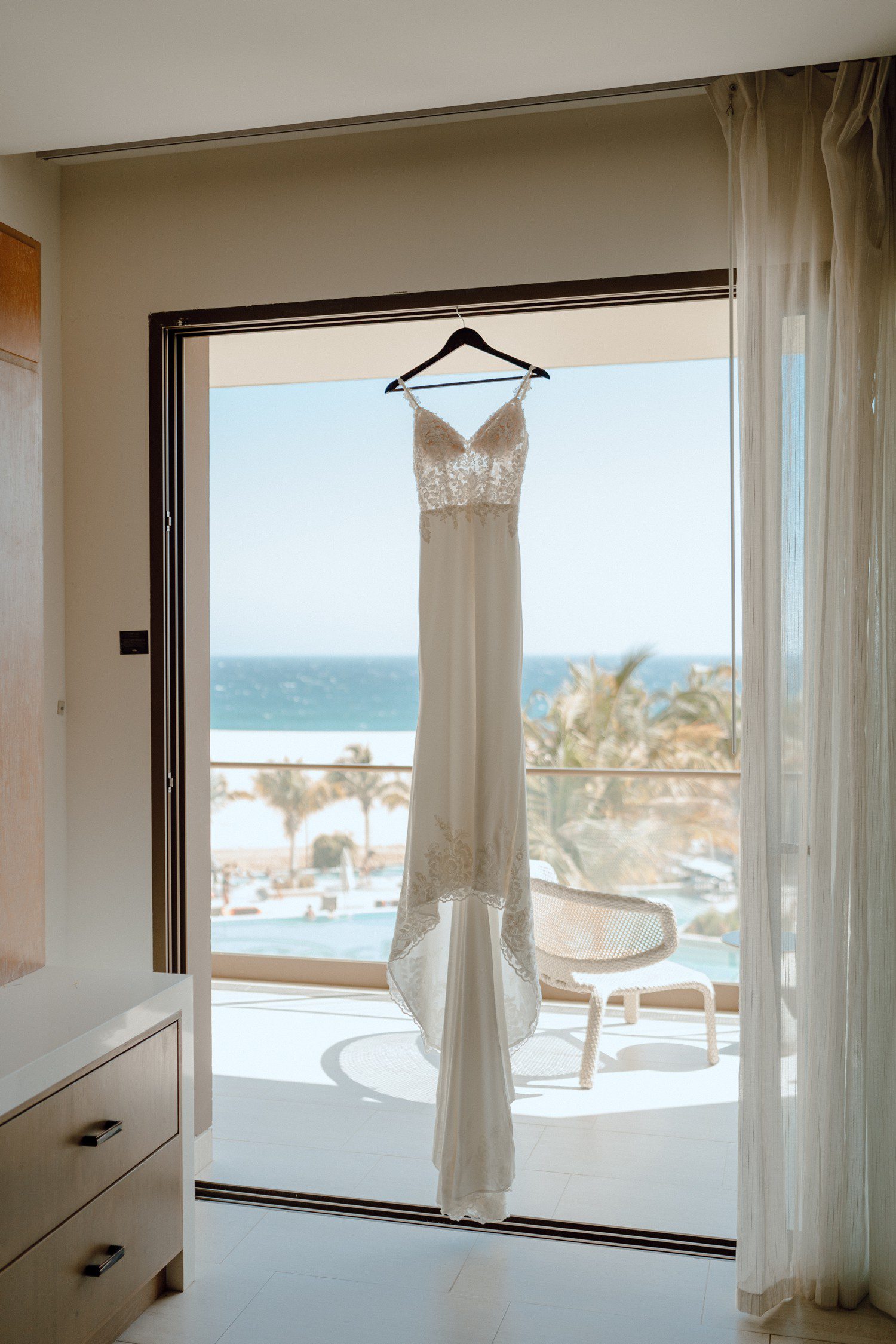 Wedding dress hanging in hotel room at Los Cabos Hard Rock Hotel. 