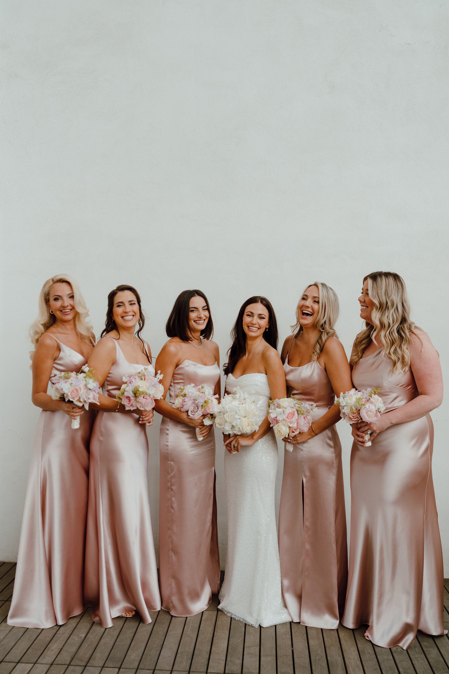 Bride with bridesmaids in pink satin dresses at the Adelphi Hotel Saratoga. 