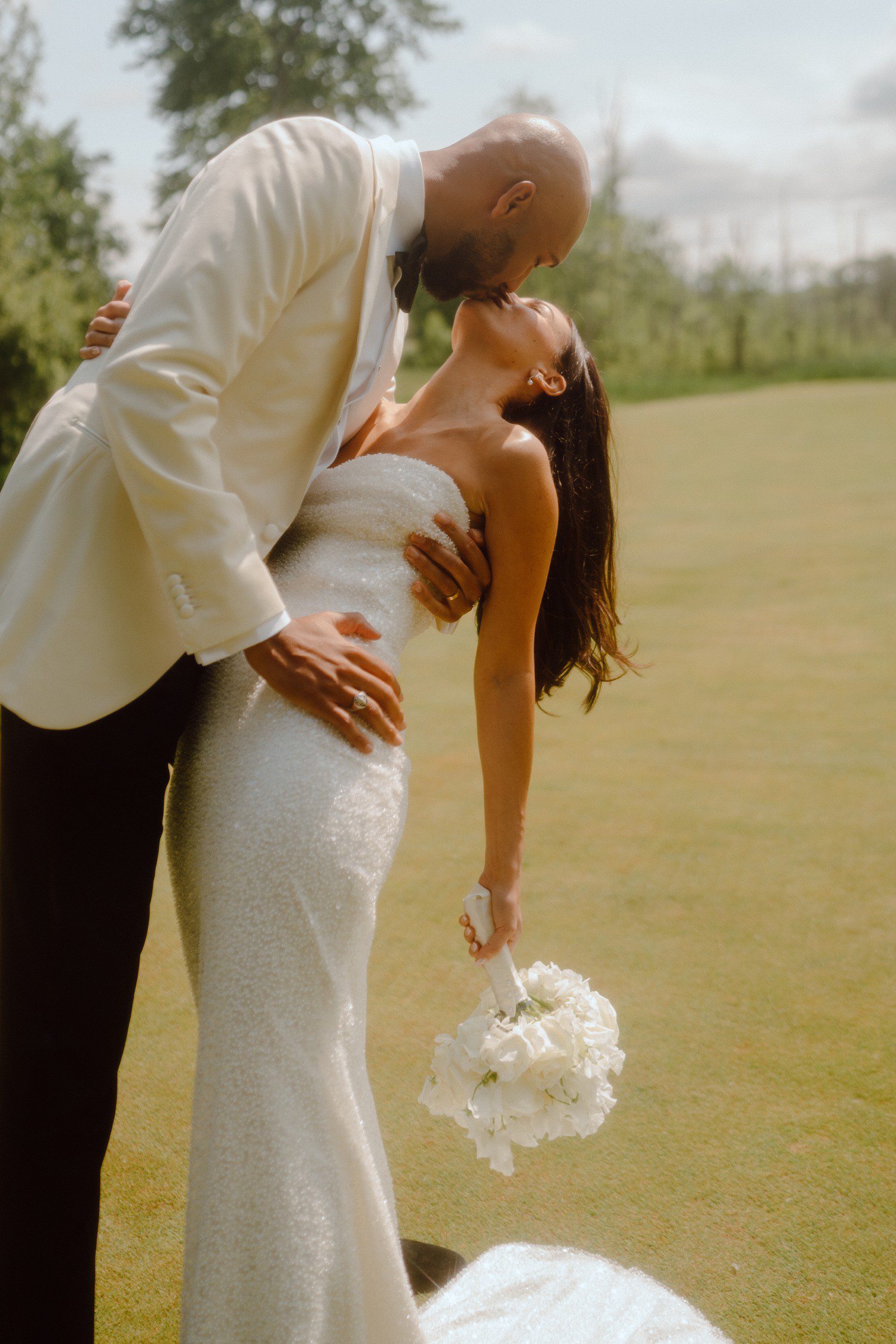 Groom dipping bride for kiss at Saratoga National Golf Club. 