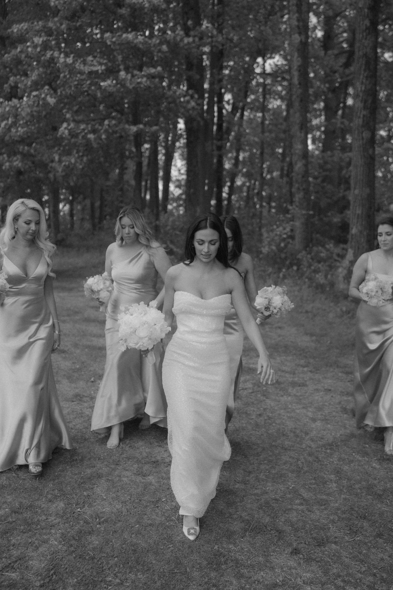 Bride and bridesmaids walking together. 