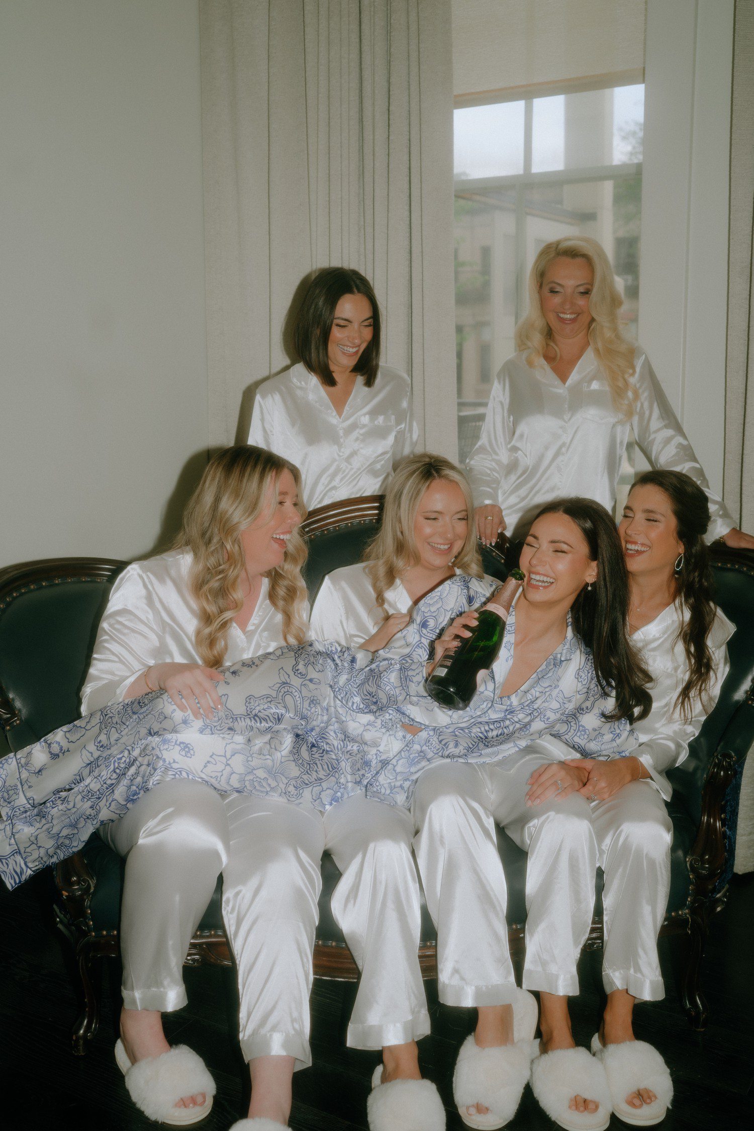 Bride and bridesmaids with champagne bottle at the Adelphi Hotel. 