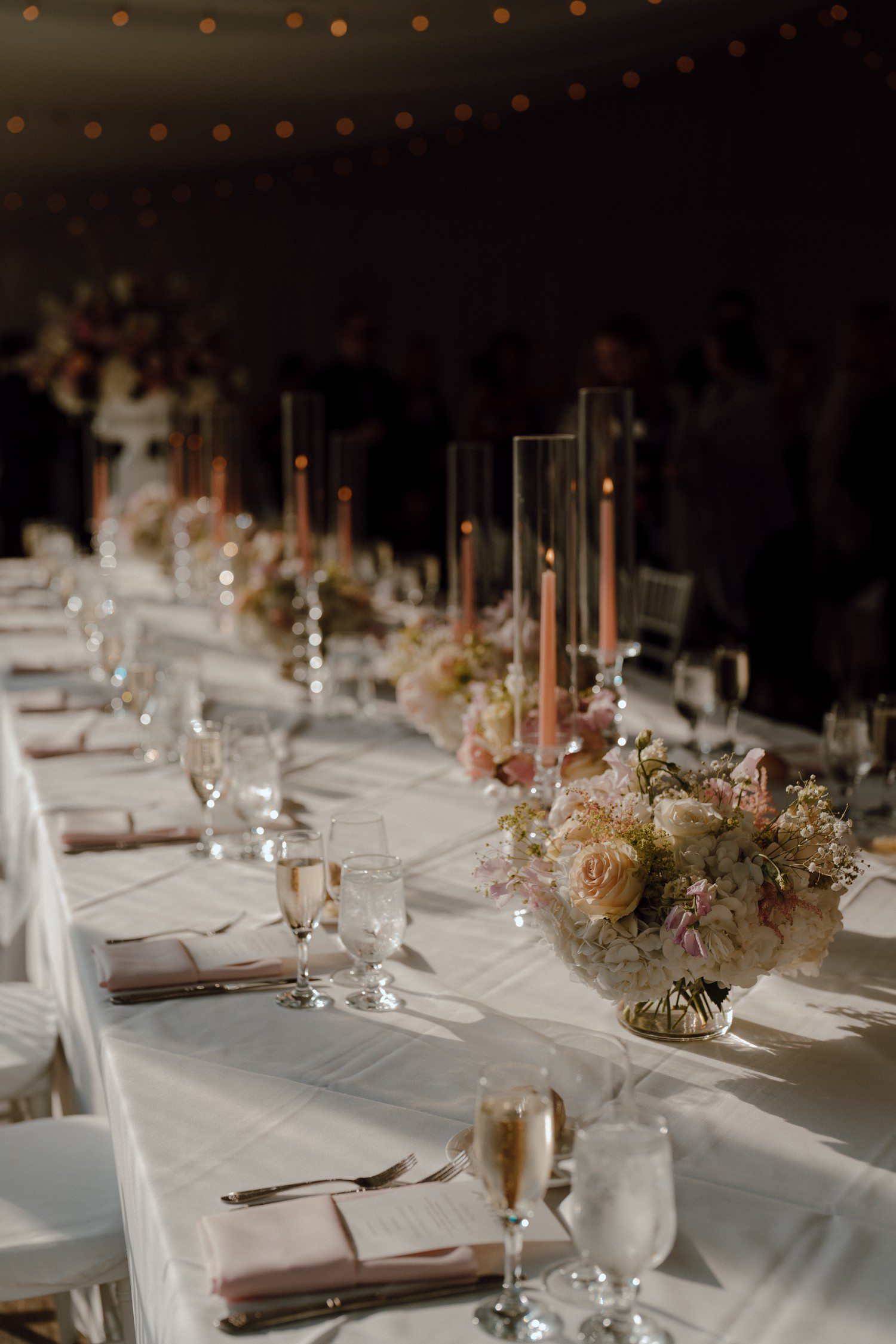 Pink and white wedding reception table decor and flowers. 