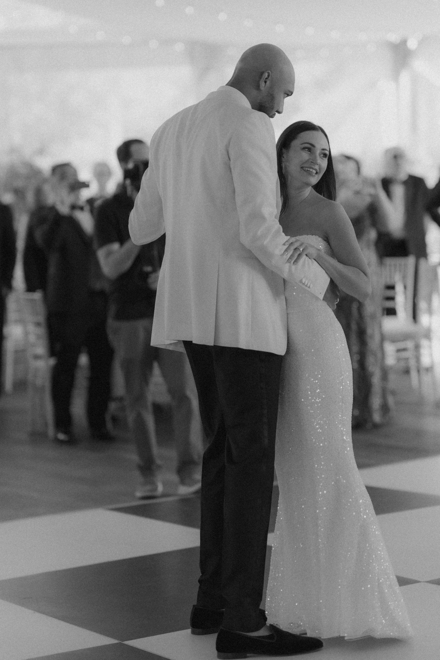 Bride and groom wedding first dance on black and white dance floor. 