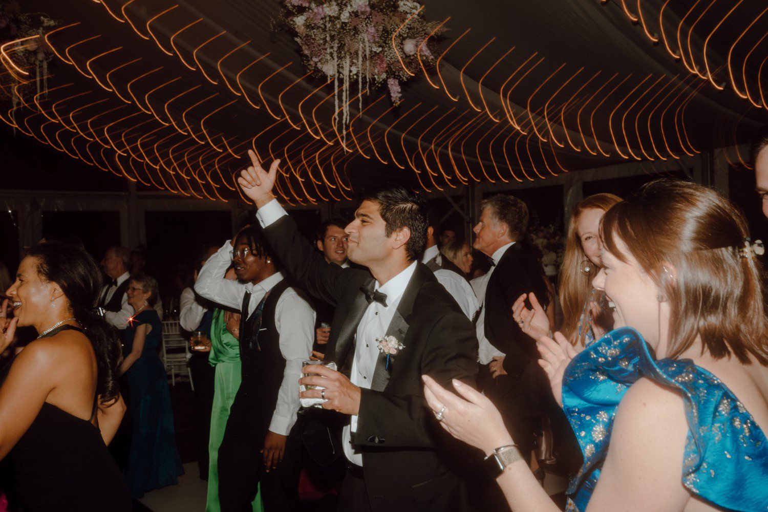Guests dancing during wedding reception. 