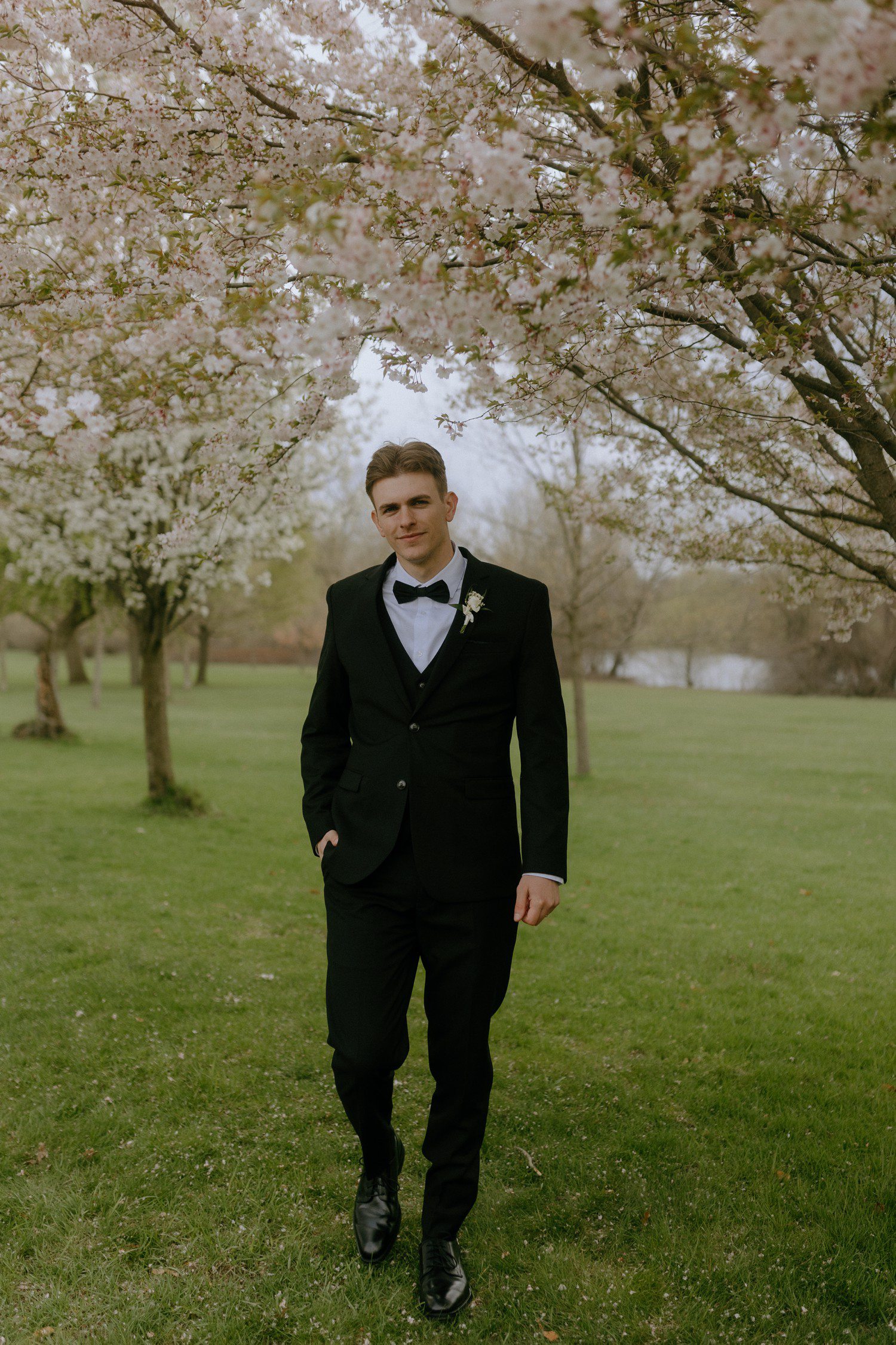 Groom wedding style in black suit with bow tie. 