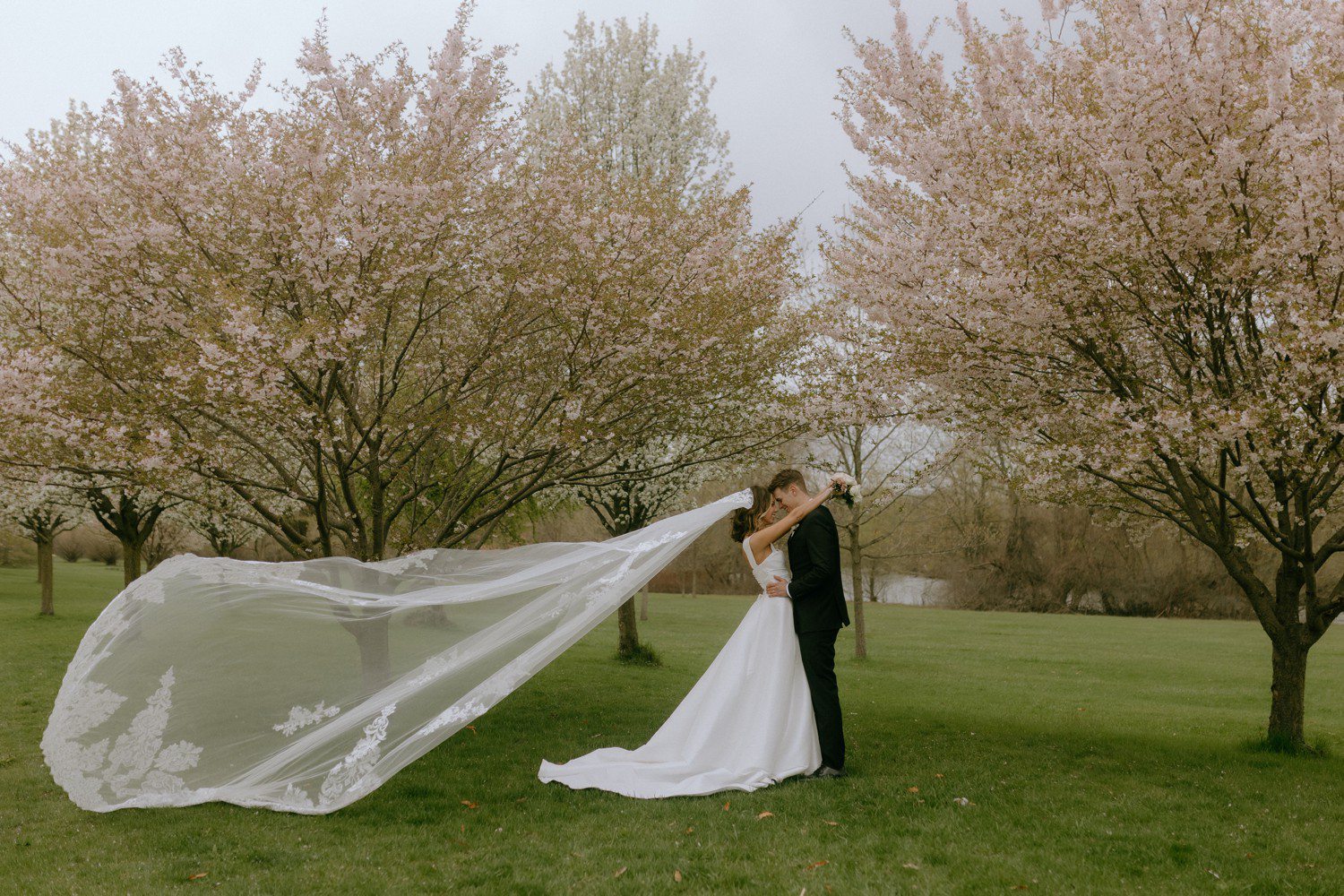 Wedding photos in Grand Rapids with bride wearing long veil.