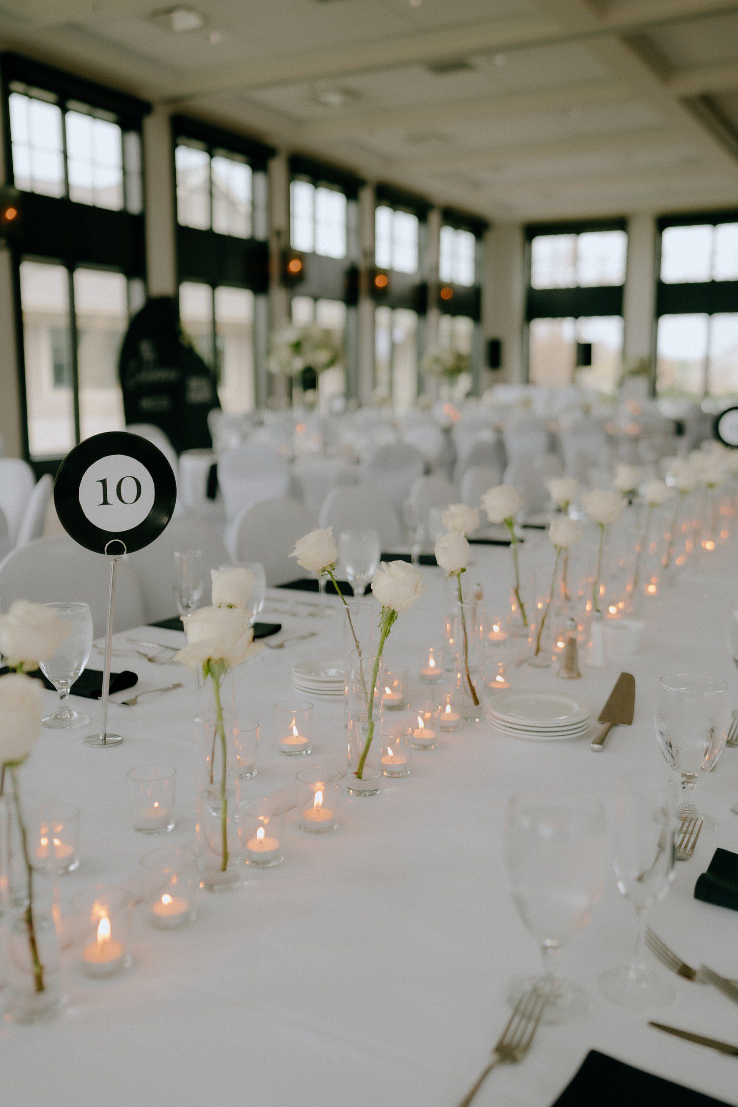 Single stem roses for wedding reception tables. 