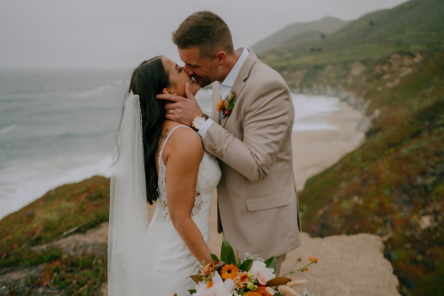 Couple kissing during beach elopement in Big Sur California. 