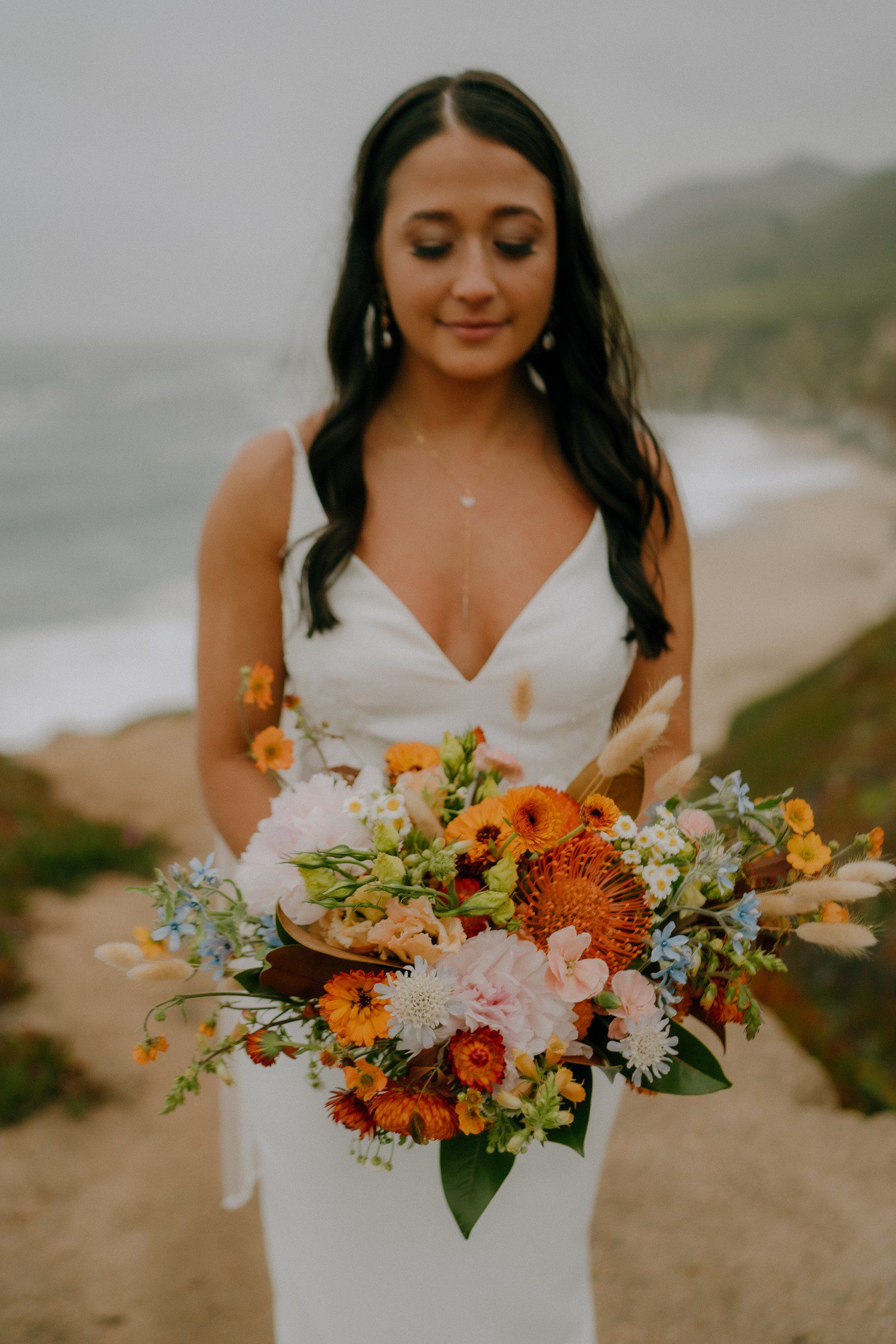 Bridal photos photos at Big Sur with colorful bouquet. 