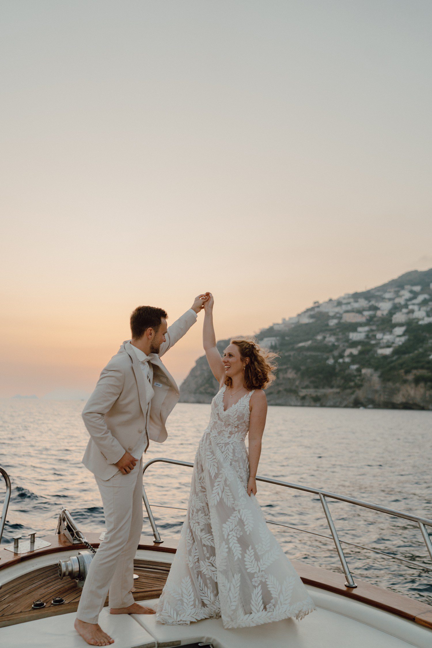 Bride and groom dancing on a boat in Positano, Italy. 