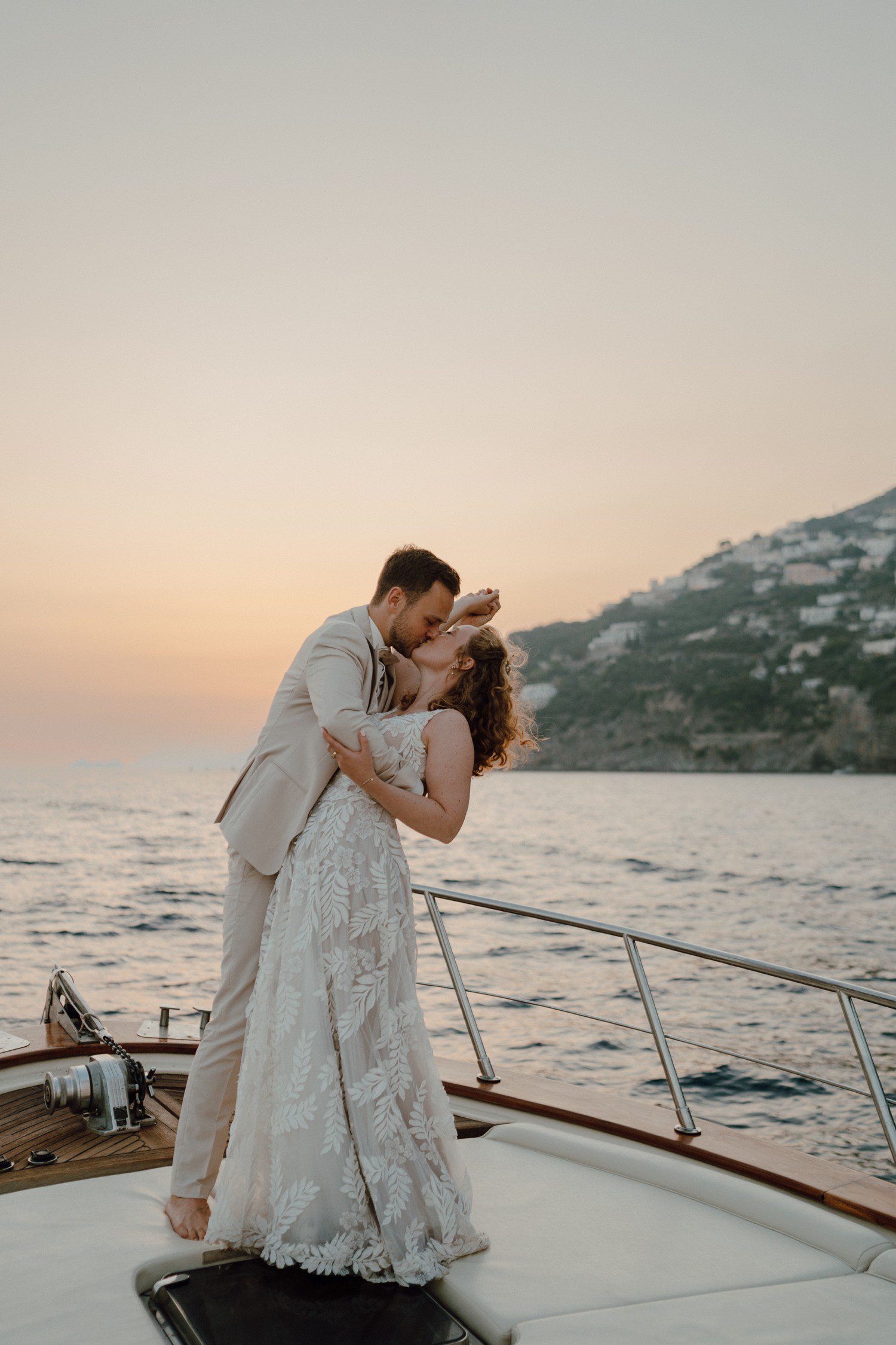 Couple kissing on boat in Positano Italy. 