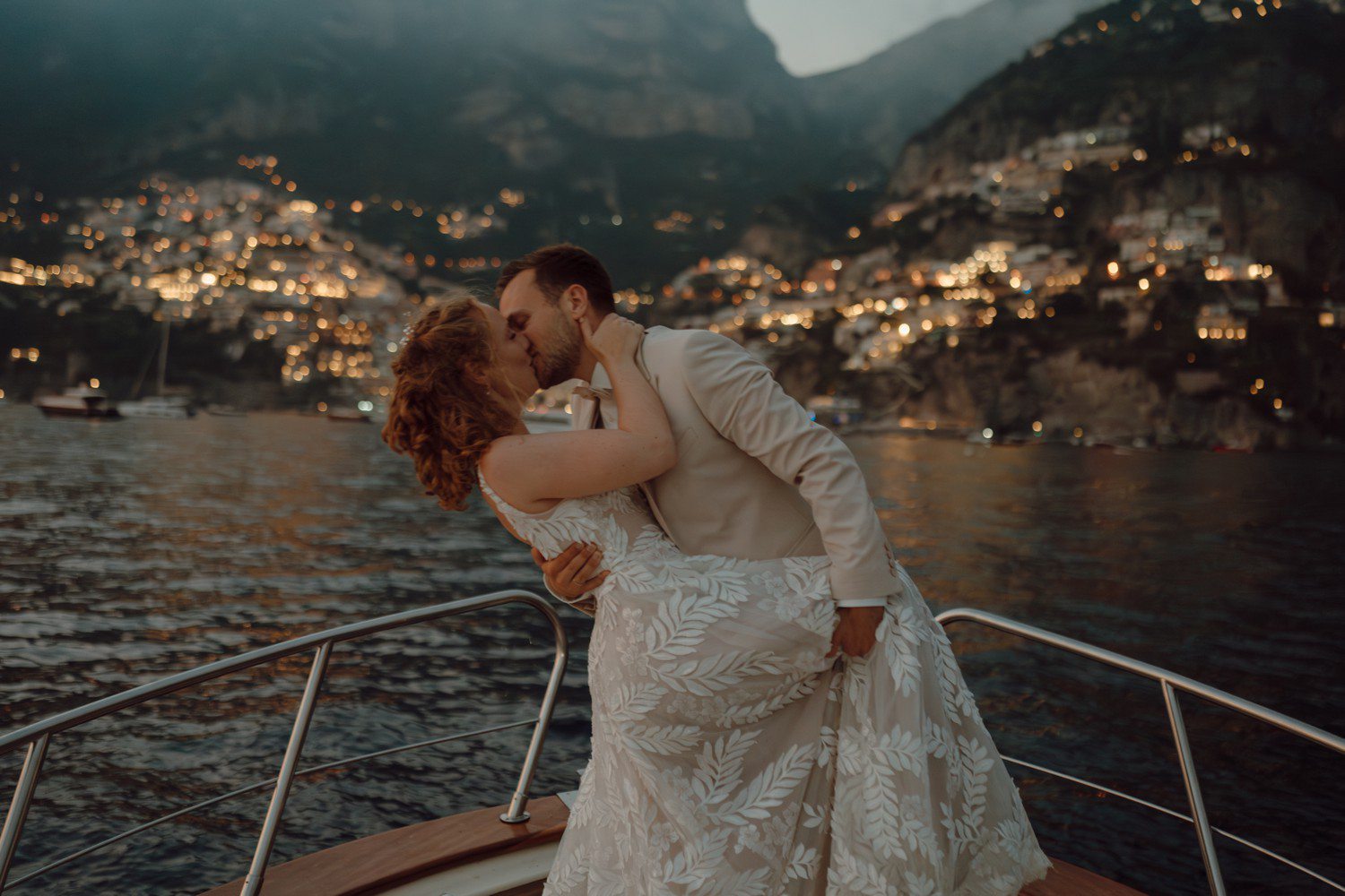 Couple kissing on boat in Positano Italy for wedding.