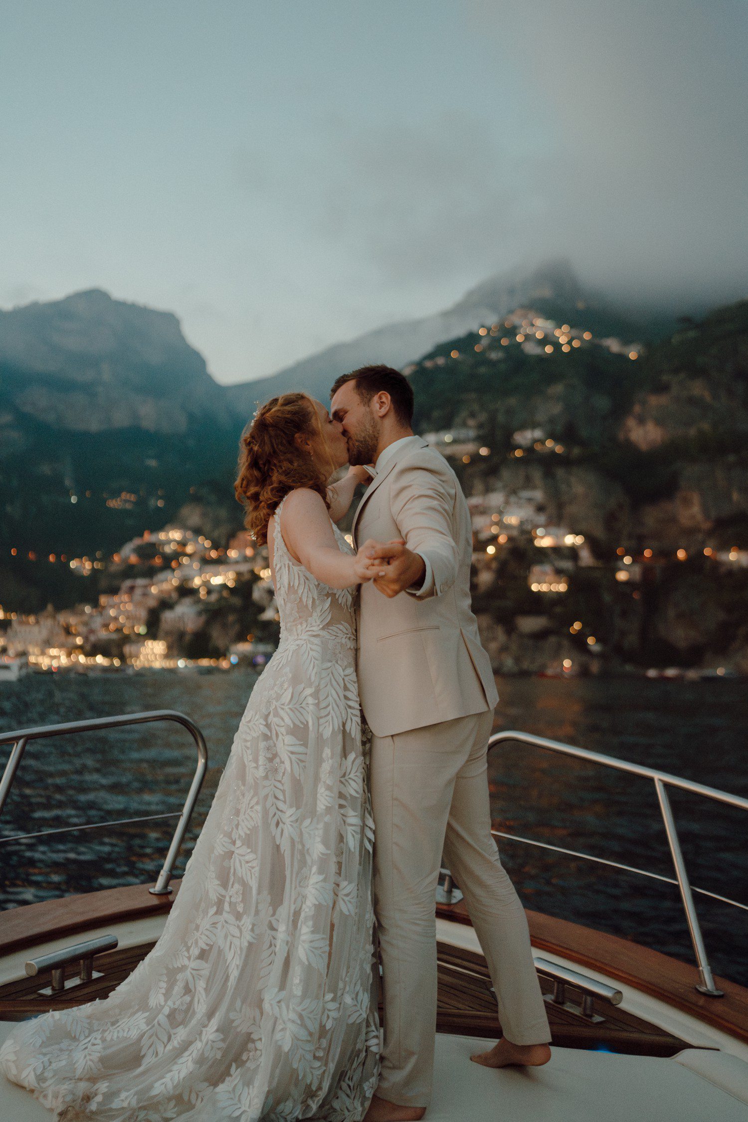 Couple kissing on a boat in Positano Italy. 