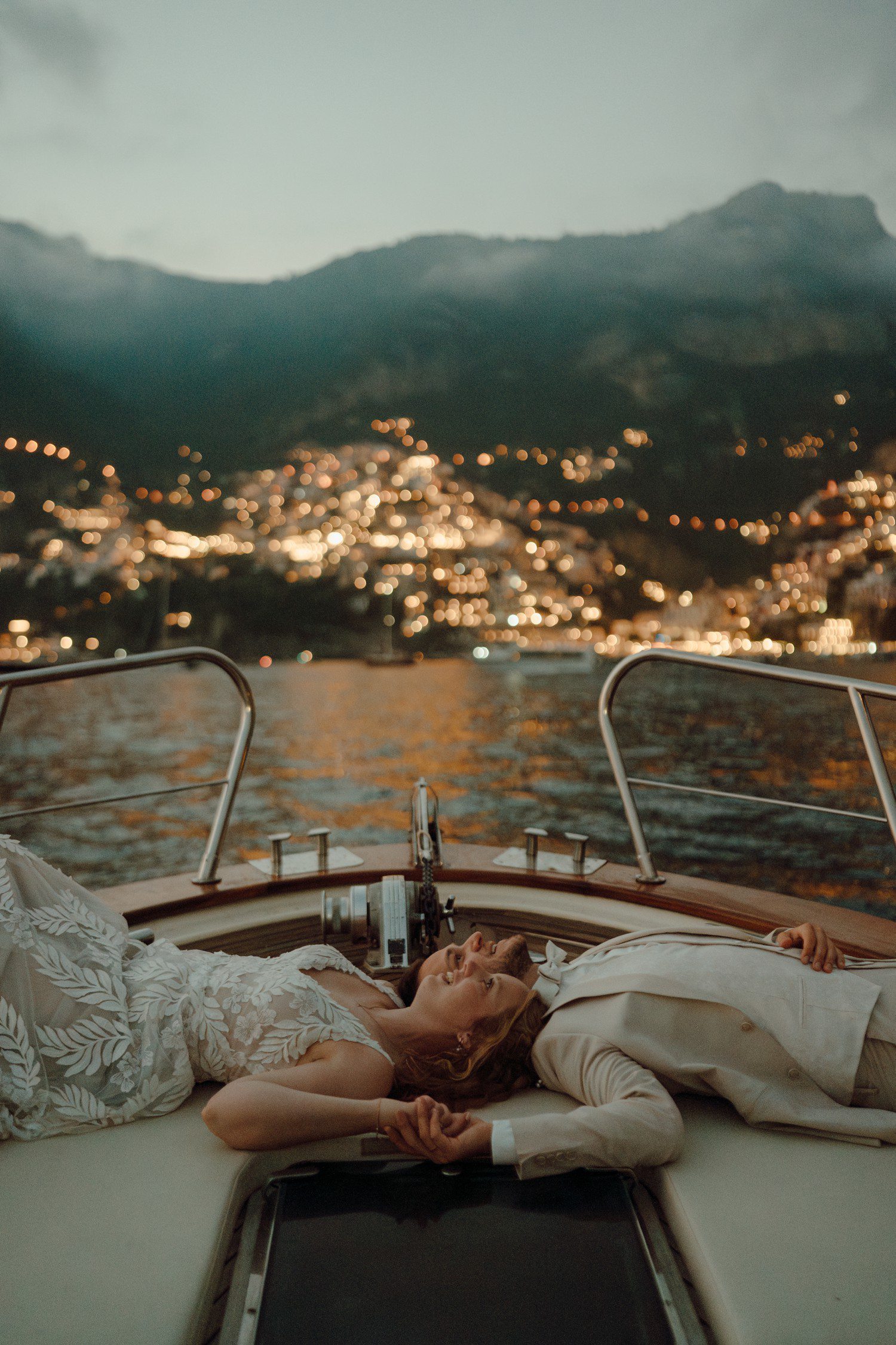 Couple lying on boat for elopement in Positano Italy. 