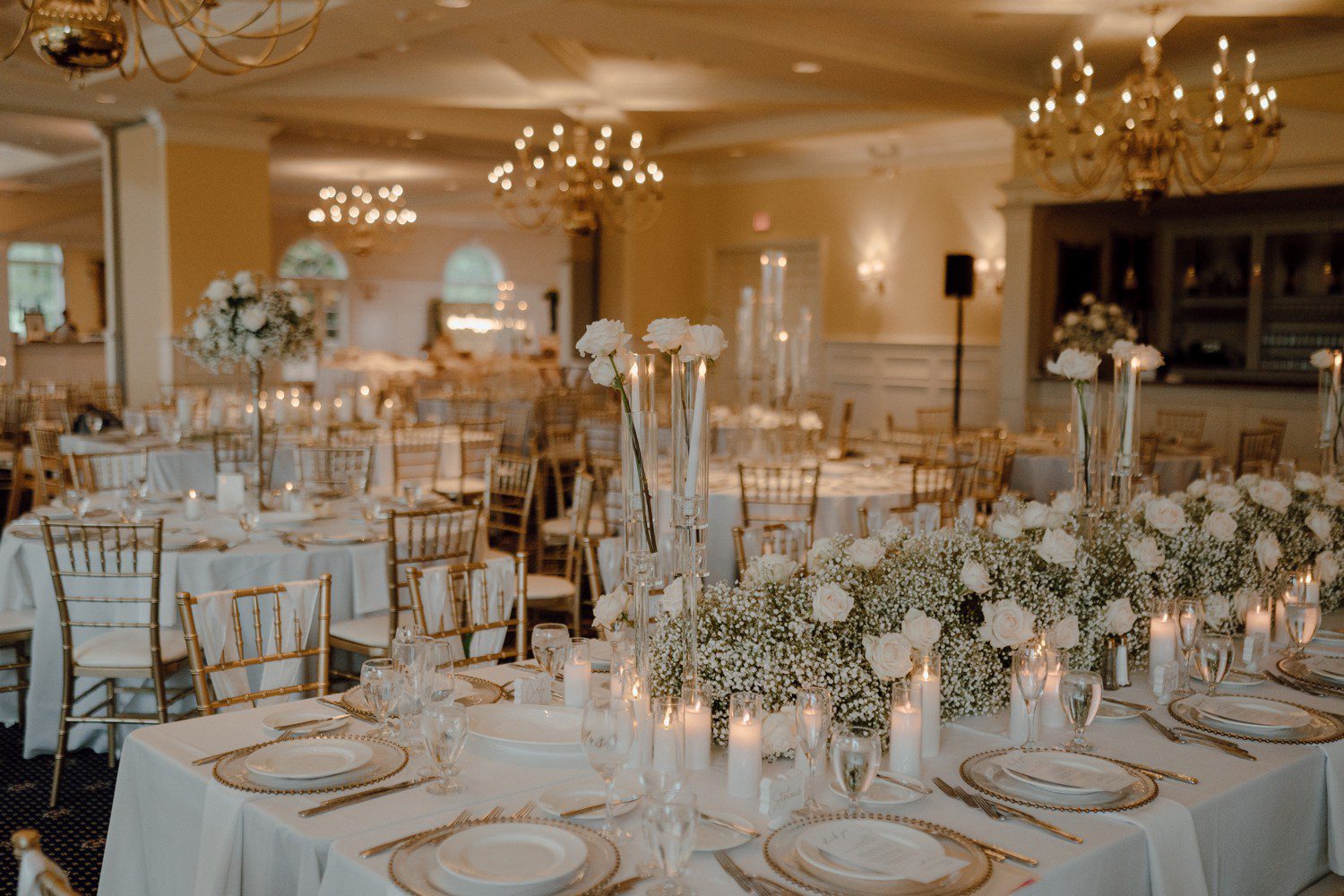 Wedding at Cherry Creek Golf Club in Michigan with white flowers decorating reception tables. 