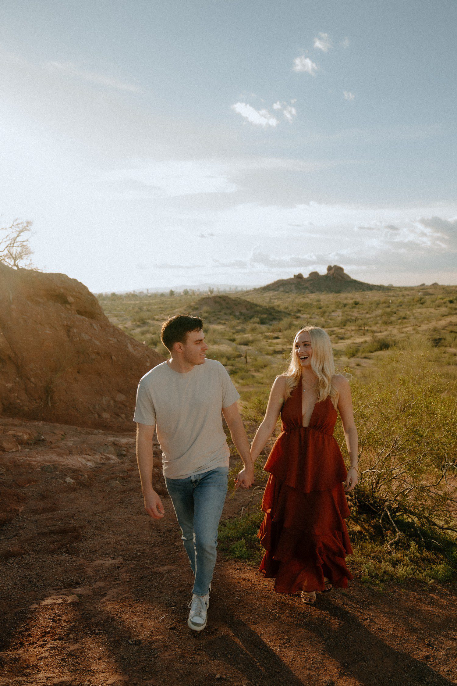 Engagement photos at Papago Park with couple walking together. 