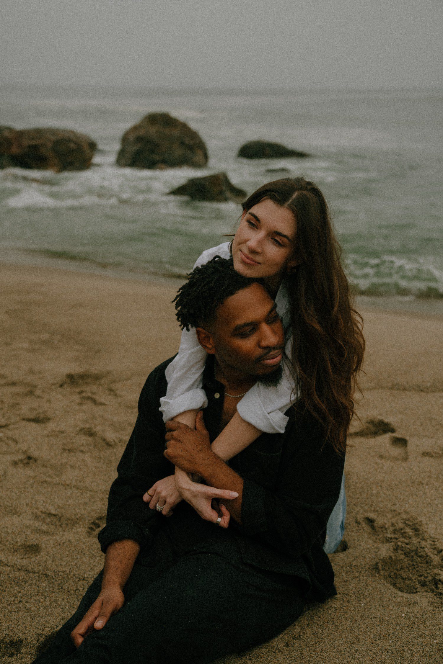 Couple sitting on the beach for Point Dume Couples Photos.