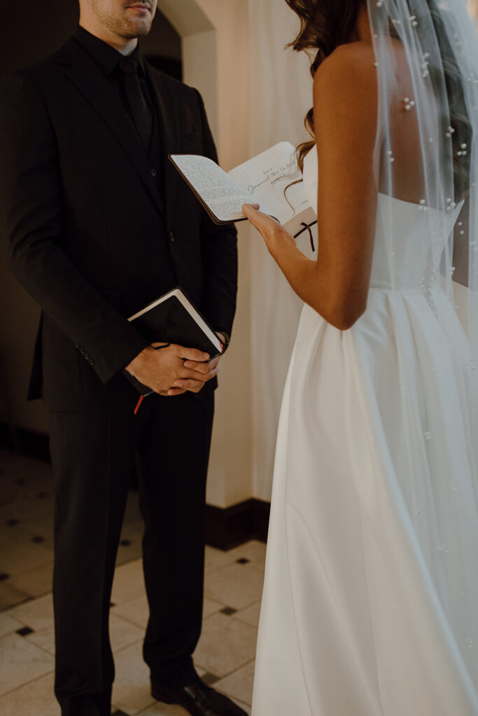 bride and groom reading their wedding vows