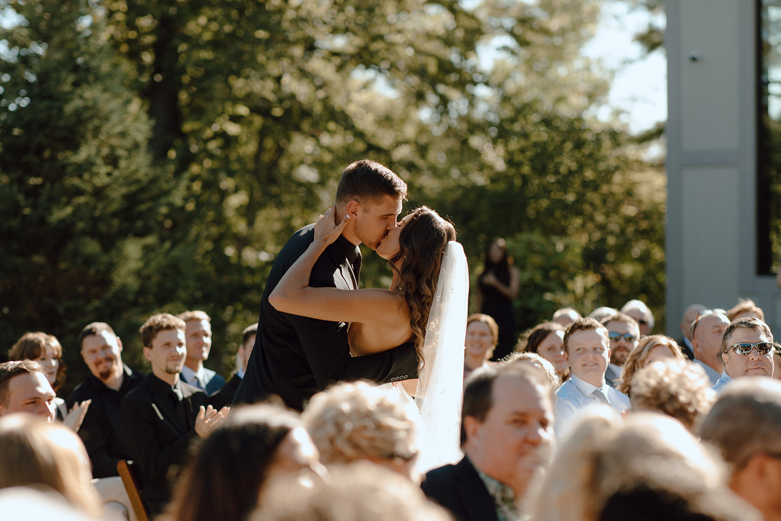 bride and groom kissing after their wedding ceremony