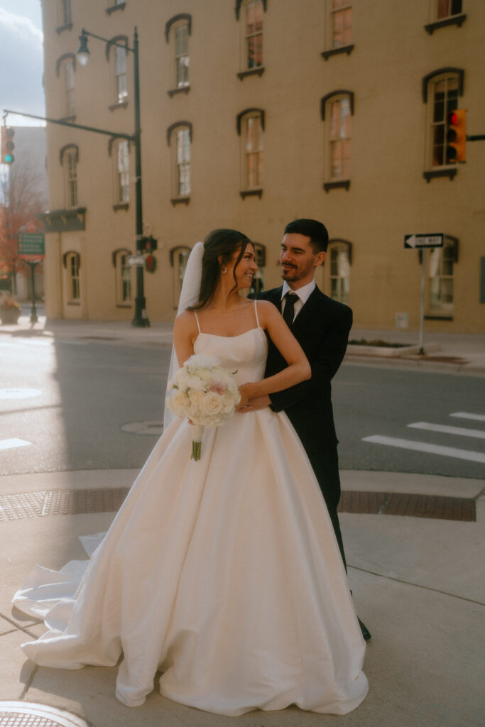 bride and groom hugging looking at each other