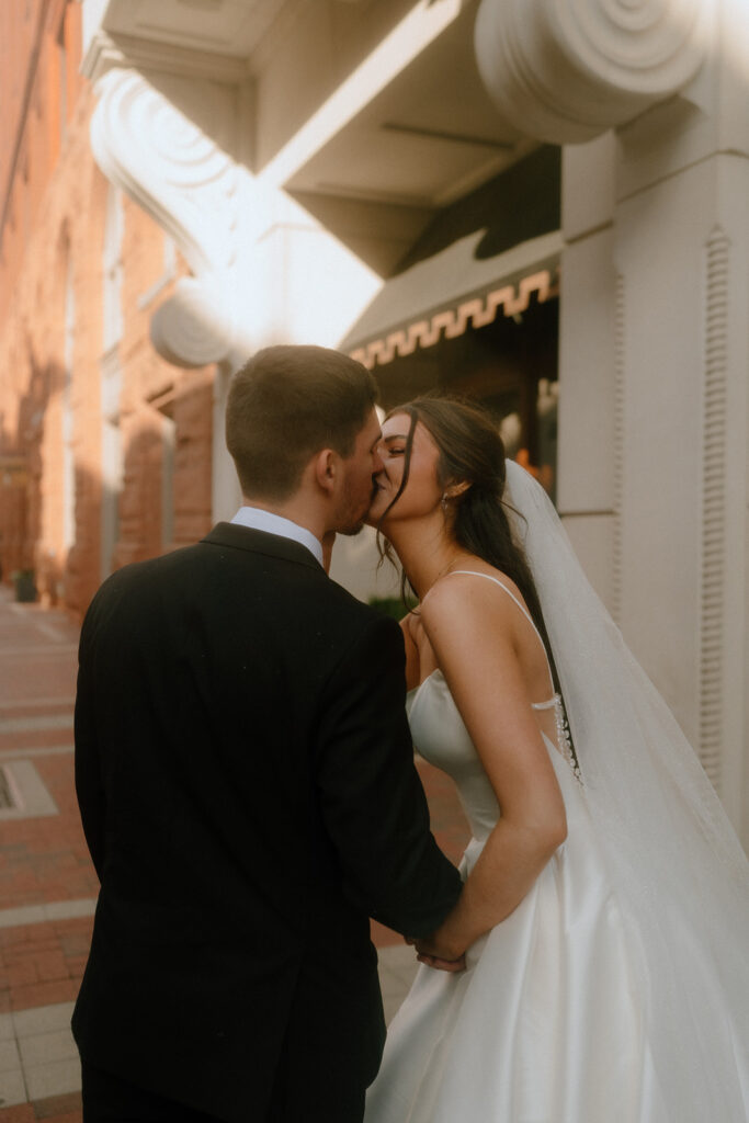 bride and groom kissing during their photoshoot