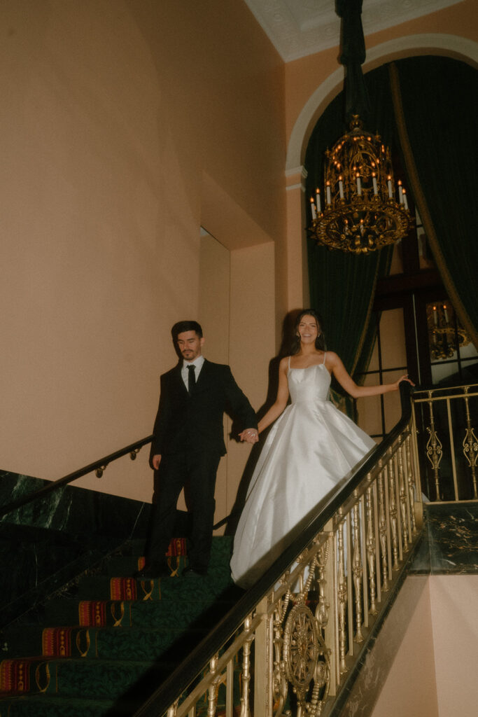 bride and groom walking down the stairs