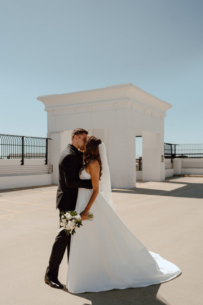 bride and groom kissing during their wedding photoshoot