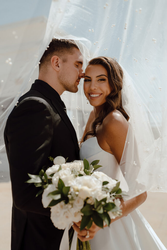 groom kissing the bride on the cheek