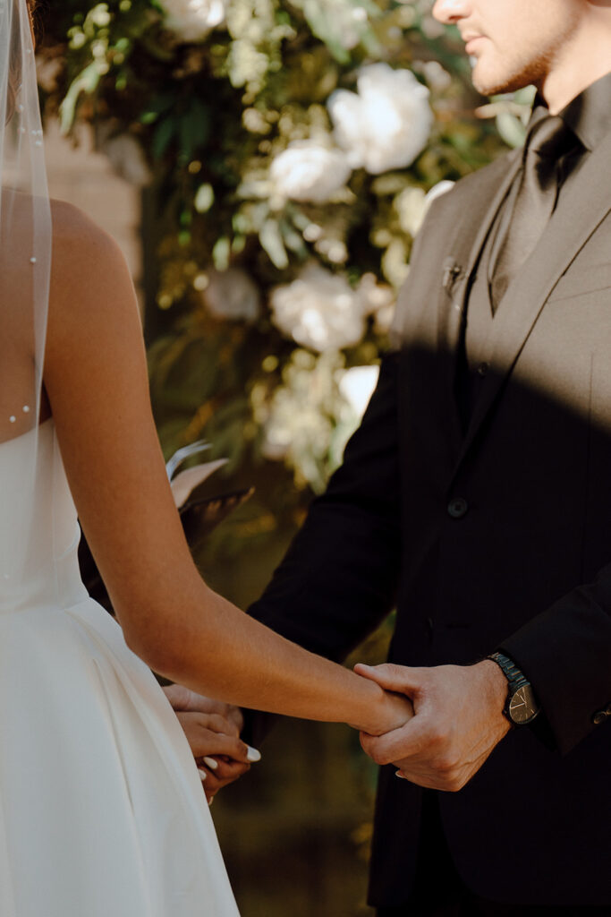 bride and groom holding hands at their wedding ceremony