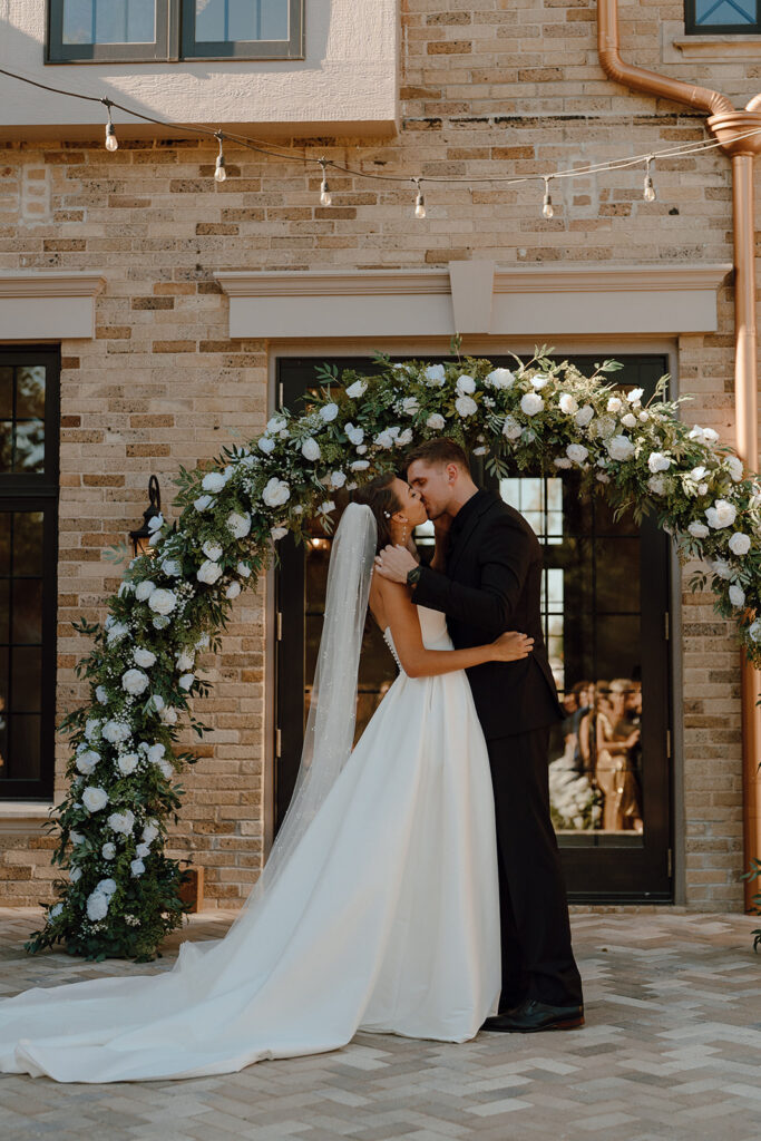 bride and groom kissing after their wedding ceremony