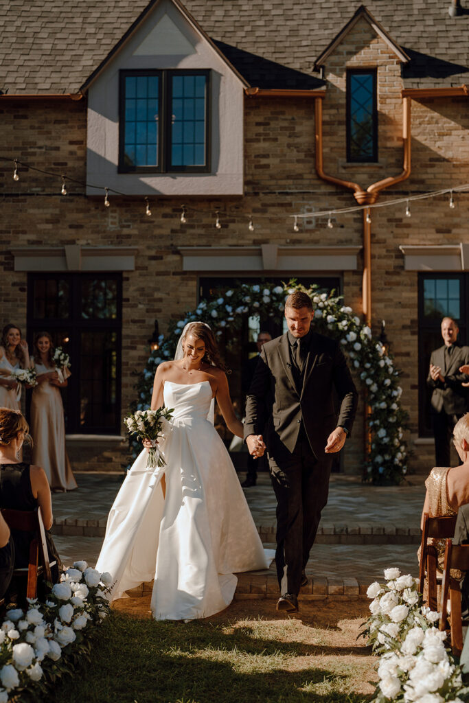 bride and groom heading to their wedding reception