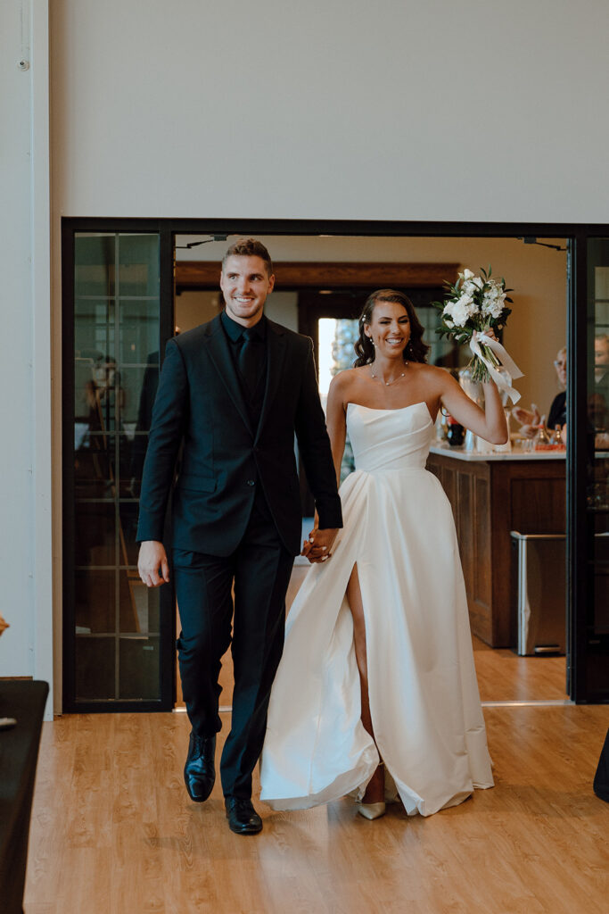 bride and groom entering their wedding reception