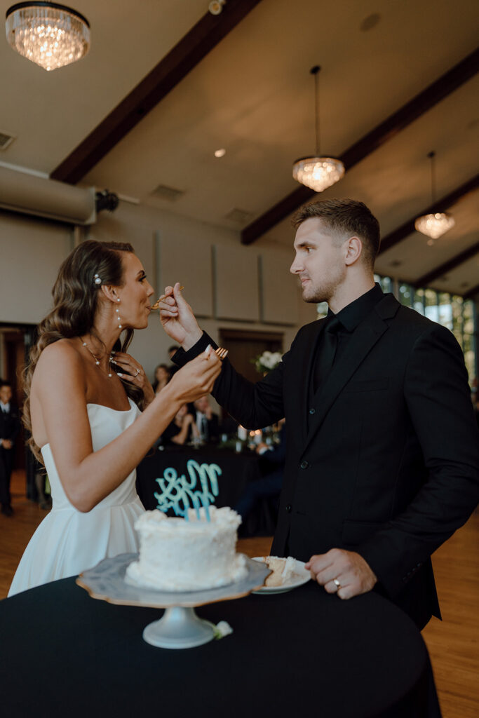 bride and groom trying their wedding cake