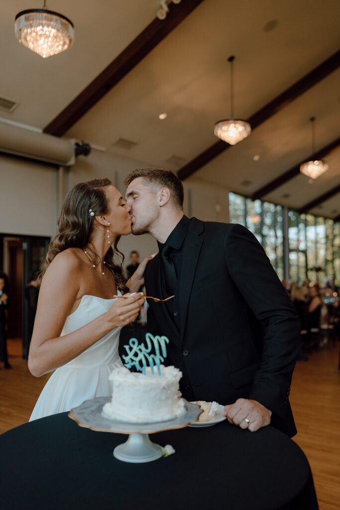 bride and groom kissing at their wedding reception