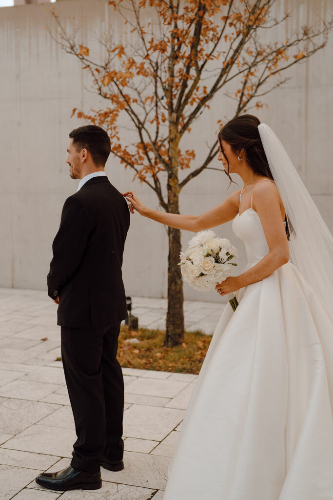 bride touching the grooms shoulder