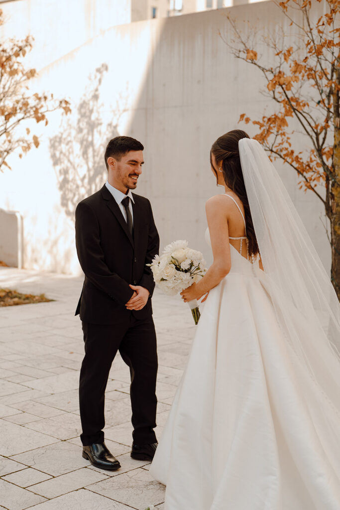 groom emotional seeing the bride in her wedding dress