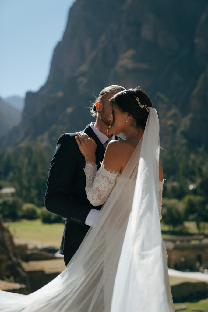 groom kissing the bride on the cheek